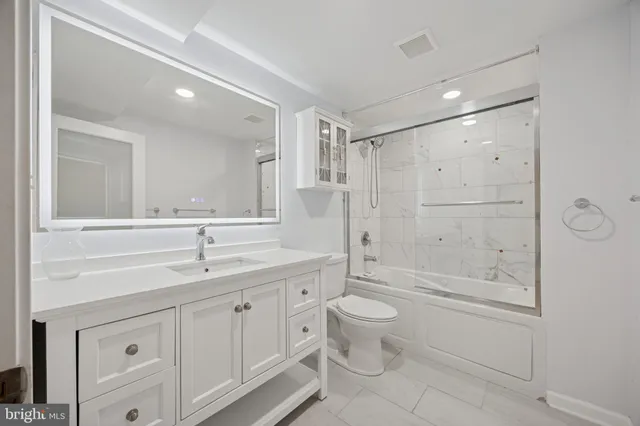 a bathroom with a double vanity sink toilet a mirror and shower
