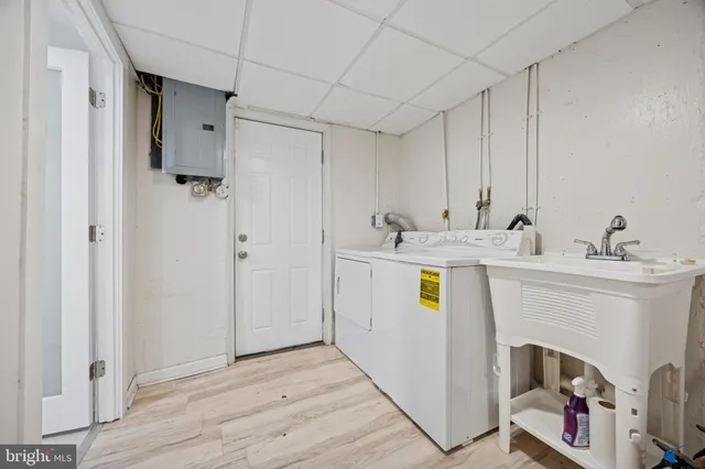 a utility room with cabinets washer and dryer