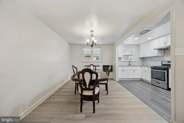 a view of a dining room with furniture and a chandelier