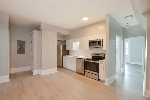 a kitchen with cabinets and stainless steel appliances