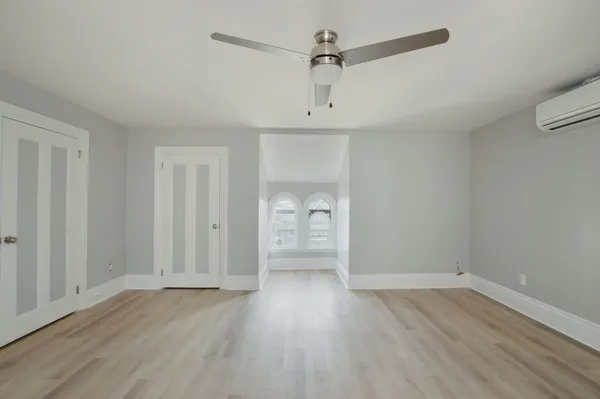 a view of empty room with wooden floor