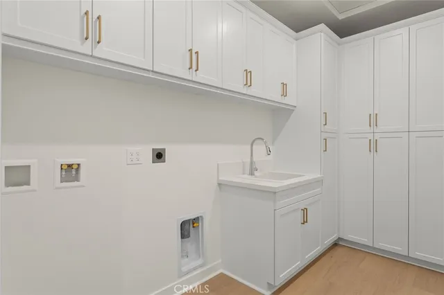 a kitchen with white cabinets and sink