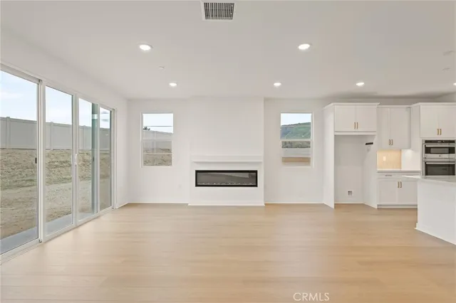 a view of kitchen with stainless steel appliances refrigerator oven and cabinets