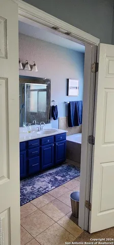 a bathroom with a vanity and a mirror