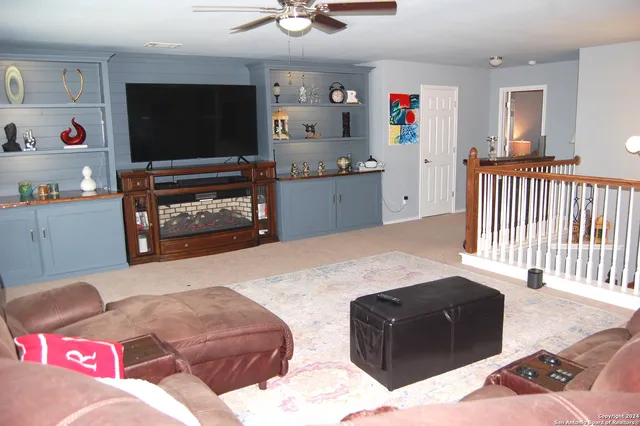 a bedroom with furniture and a flat screen tv