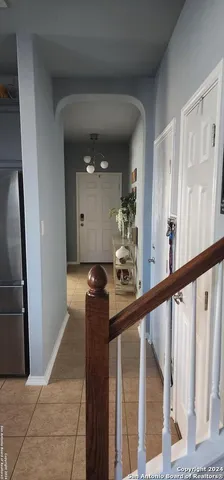 a view of a hallway with wooden floor and stairs