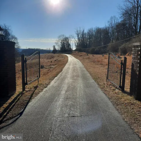 a view of a pathway with a wrought fence