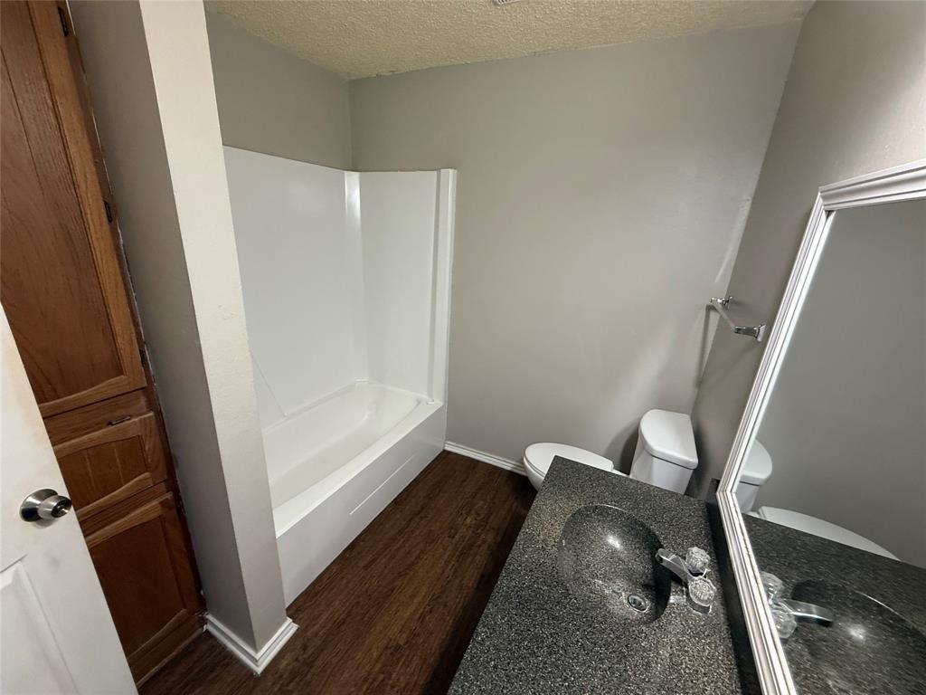 1610 Sun Valley Drive, Unit A Cleburne, TX 76033 - Photo 4 of 8 a view of utility room with wooden floor