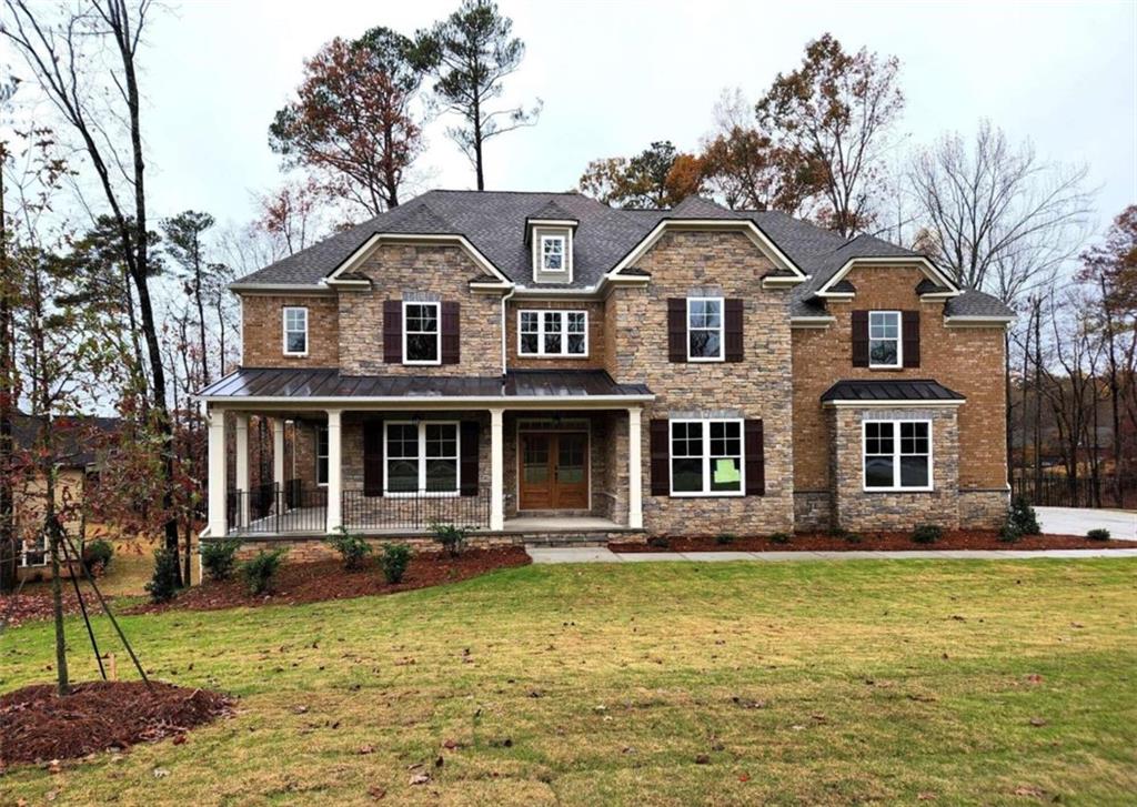 a front view of a house with a yard table and chairs