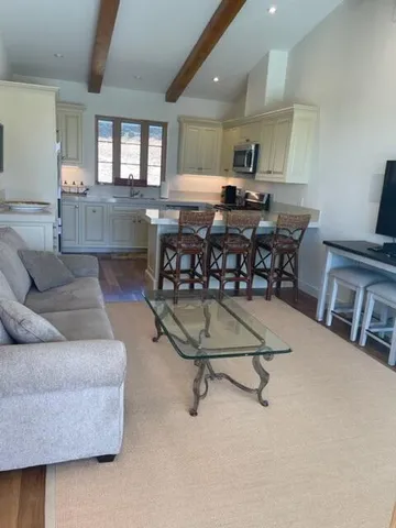 a living room with furniture and kitchen view
