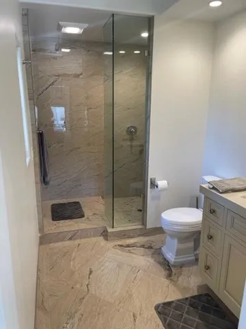 a bathroom with a toilet and a shower