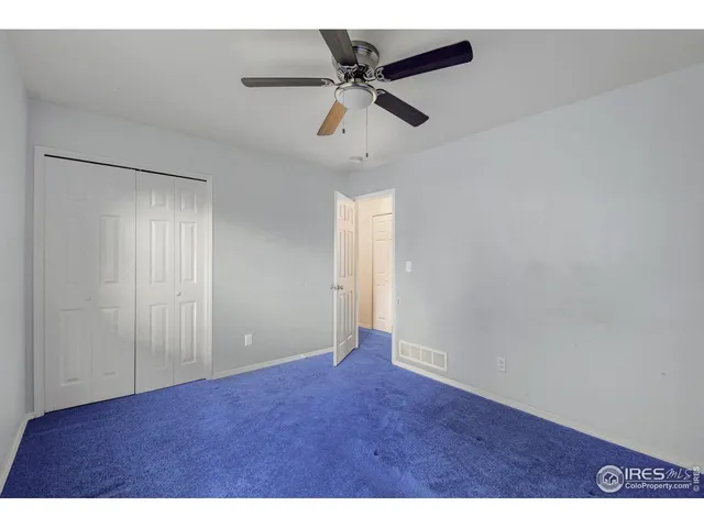 a view of an empty room with a ceiling fan