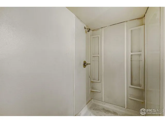 a bathroom with a shower and a sink