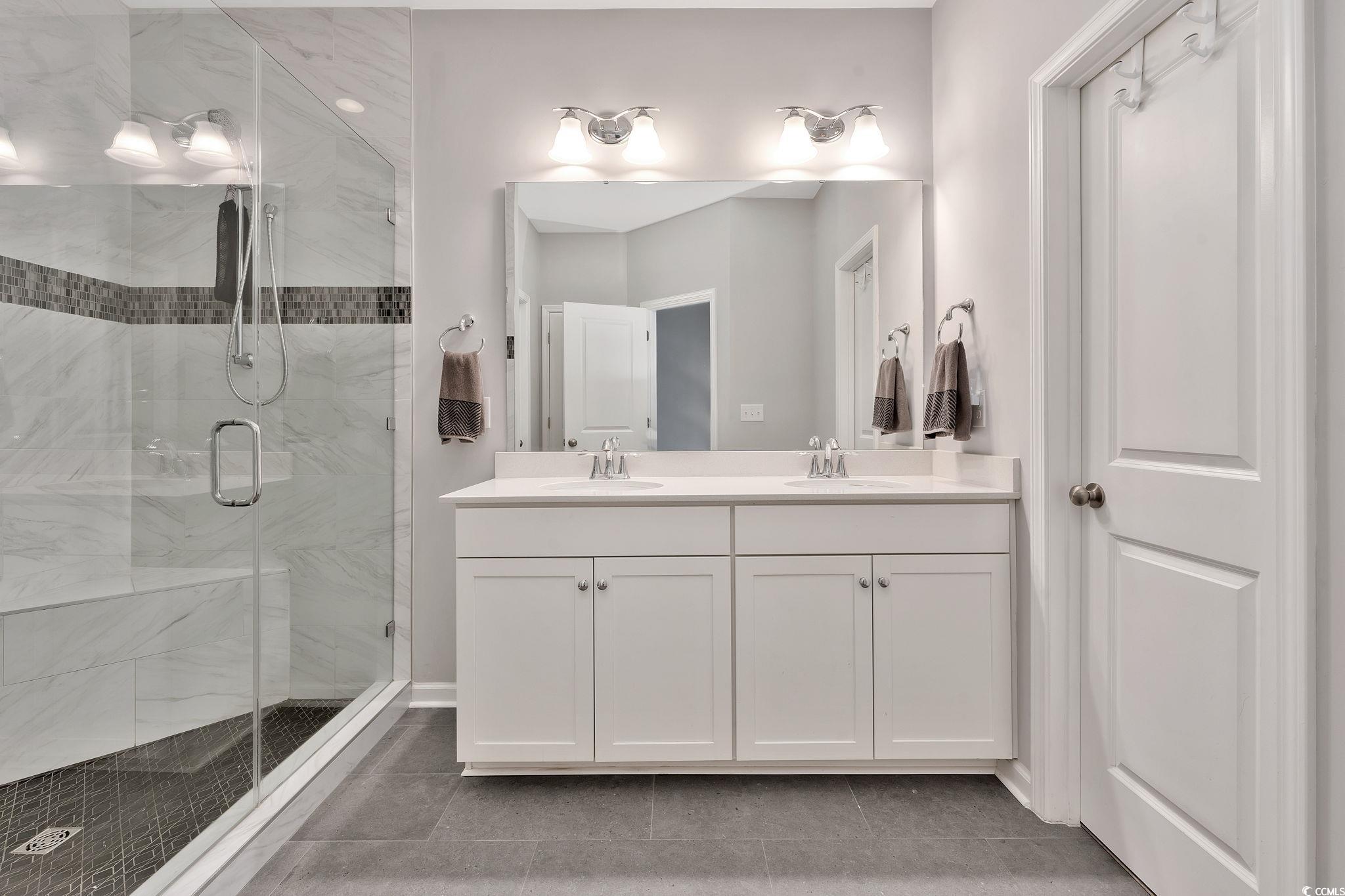141 Splendor Circle Murrells Inlet, SC 29576 - Photo 20 of 34 Bathroom with double vanity, tile patterned floori