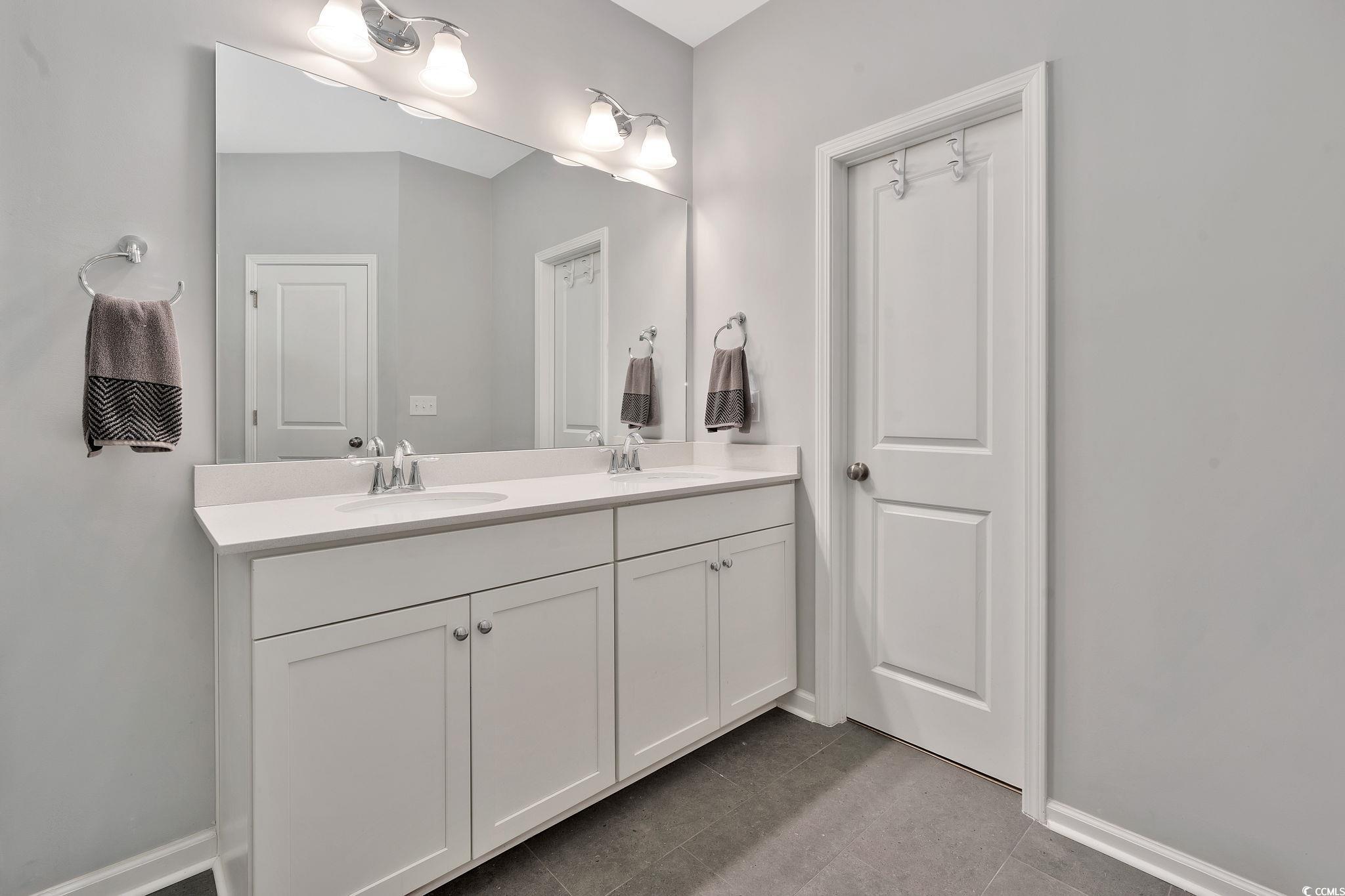 141 Splendor Circle Murrells Inlet, SC 29576 - Photo 25 of 34 Bathroom with double vanity, a sink, and baseboard