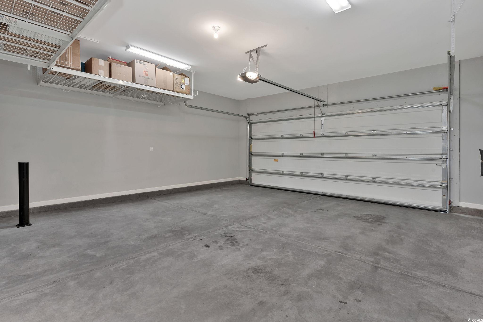 141 Splendor Circle Murrells Inlet, SC 29576 - Photo 29 of 34 Garage with a garage door opener and baseboards