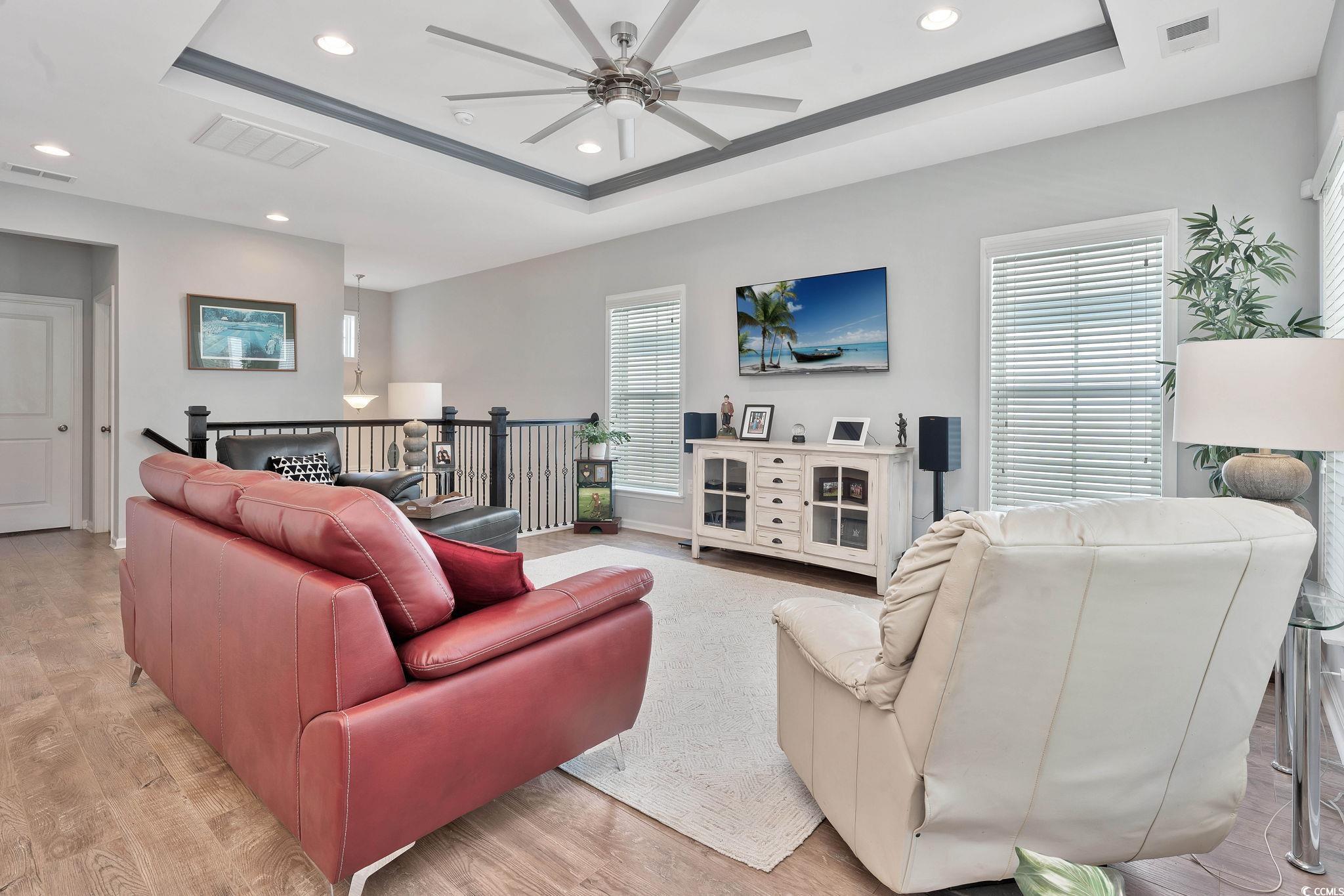 141 Splendor Circle Murrells Inlet, SC 29576 - Photo 6 of 34 Living room with a tray ceiling, visible vents, an