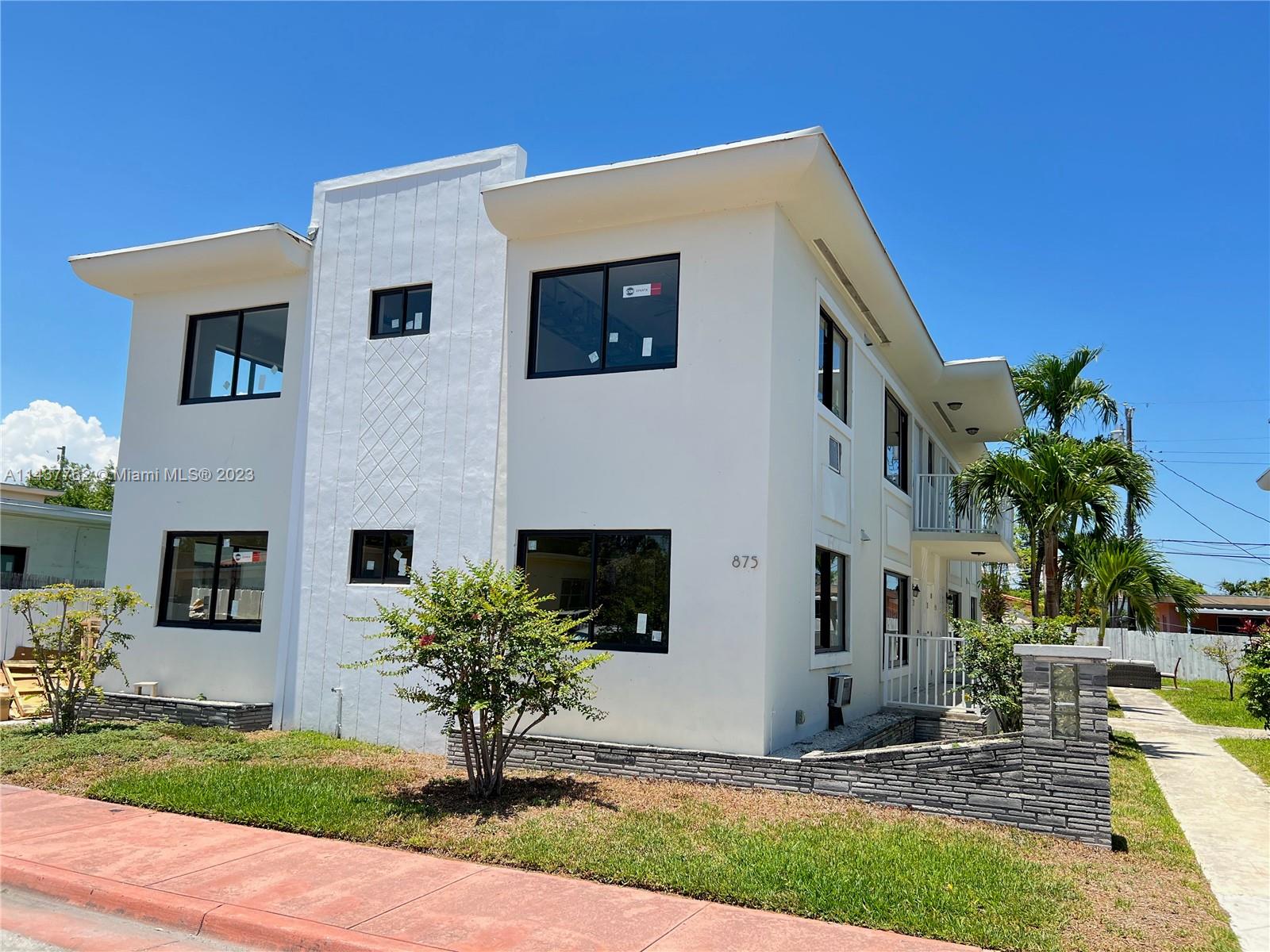 875 80th Street, Unit 3 Miami Beach, FL 33141 - Photo 1 of 15 a front view of house with yard