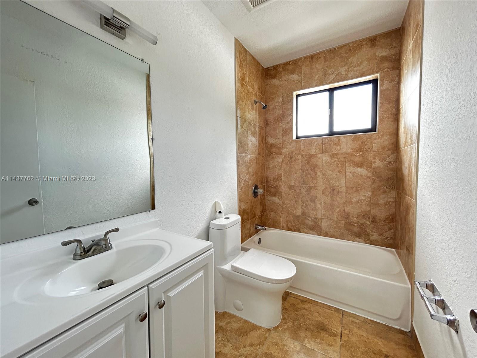 875 80th Street, Unit 3 Miami Beach, FL 33141 - Photo 12 of 15 a bathroom with a sink toilet and shower