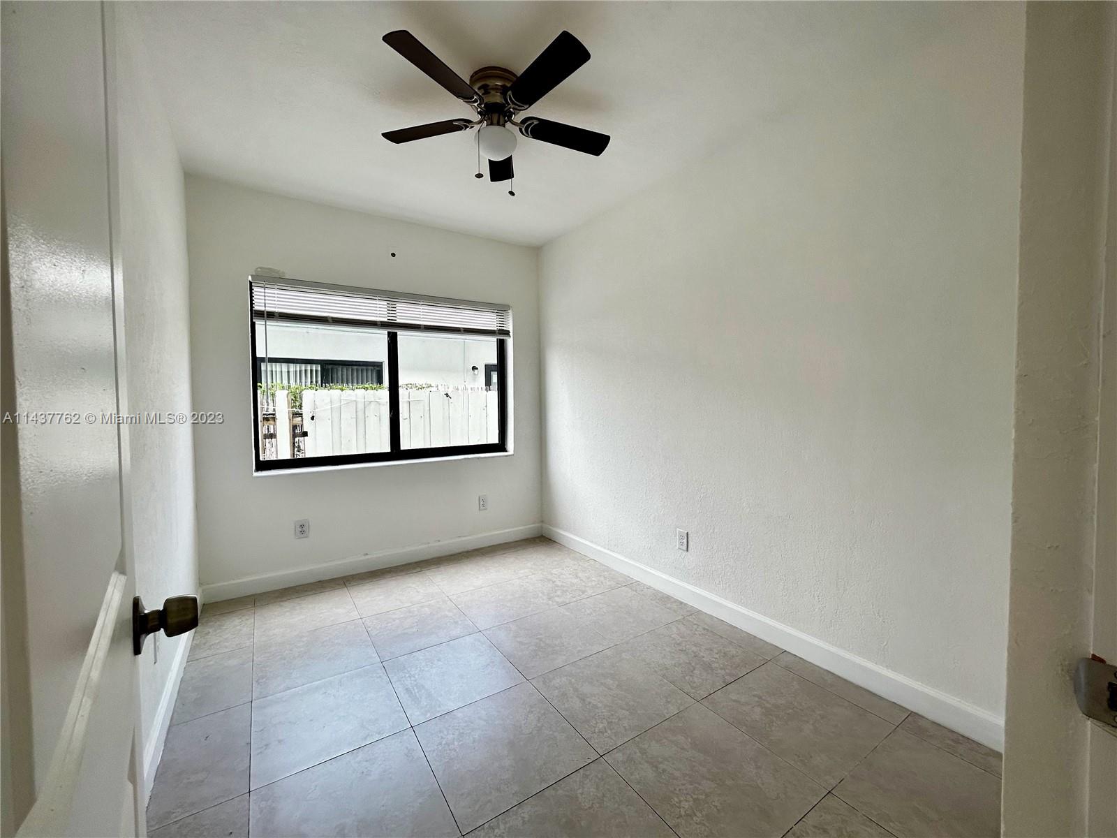 875 80th Street, Unit 3 Miami Beach, FL 33141 - Photo 4 of 15 an empty room with windows and closet