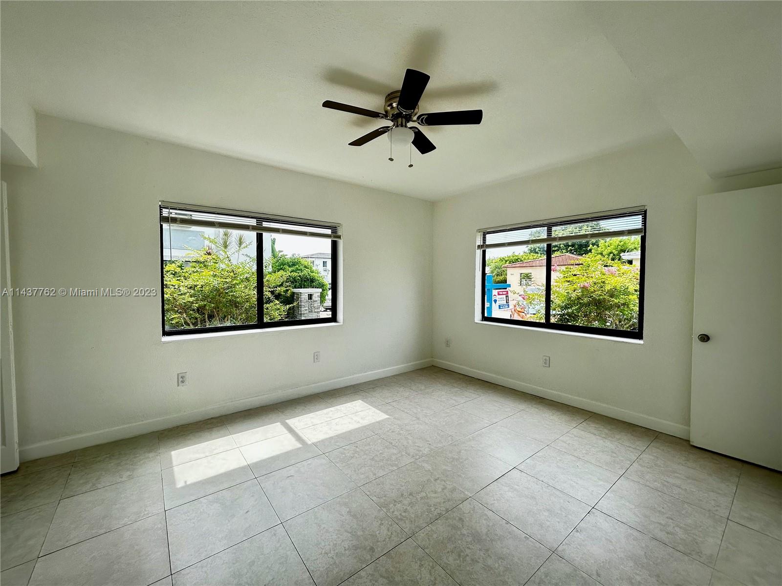 875 80th Street, Unit 3 Miami Beach, FL 33141 - Photo 5 of 15 a view of an empty room with a window