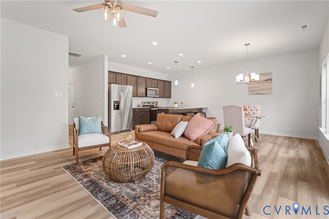 11348 Benton Pointe Way Chester, VA 23831 - Photo 12 of 45 a living room with furniture and a chandelier