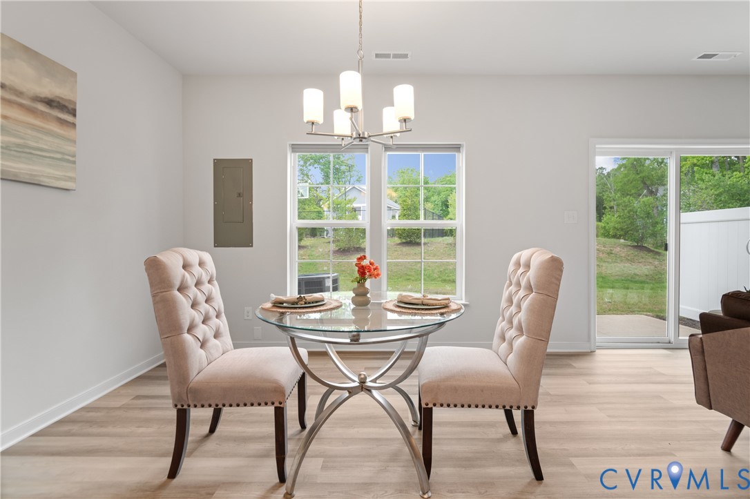 11348 Benton Pointe Way Chester, VA 23831 - Photo 15 of 45 a dining room with furniture a chandelier and wooden floor