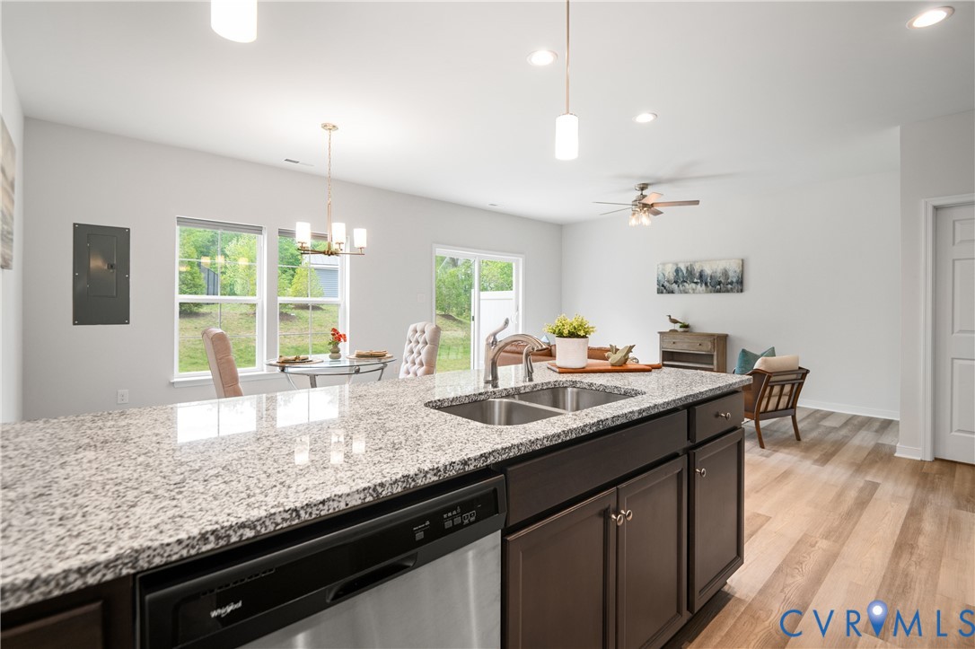 11348 Benton Pointe Way Chester, VA 23831 - Photo 20 of 45 a kitchen with granite countertop kitchen island a sink a counter space and windows