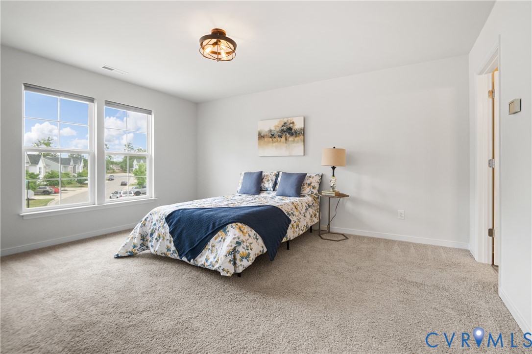 11348 Benton Pointe Way Chester, VA 23831 - Photo 25 of 45 a spacious bedroom with a bed and a window
