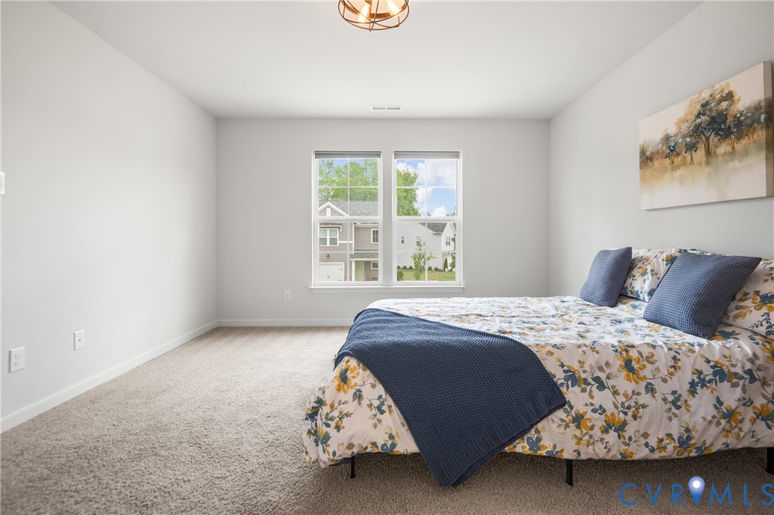 11348 Benton Pointe Way Chester, VA 23831 - Photo 26 of 45 a bedroom with a bed and a window