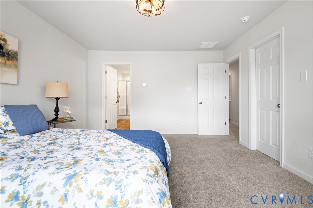 11348 Benton Pointe Way Chester, VA 23831 - Photo 27 of 45 a bedroom with a bed and a lamp