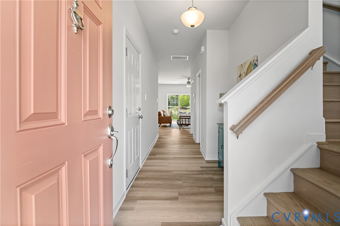 11348 Benton Pointe Way Chester, VA 23831 - Photo 4 of 45 a view of a hallway with wooden floor and staircase