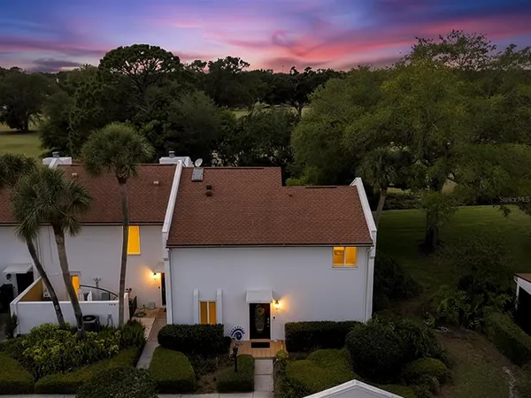 an aerial view of a house with a yard basket ball court and outdoor seating