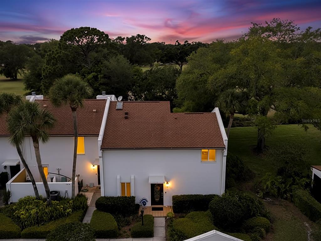 an aerial view of a house with a yard basket ball court and outdoor seating