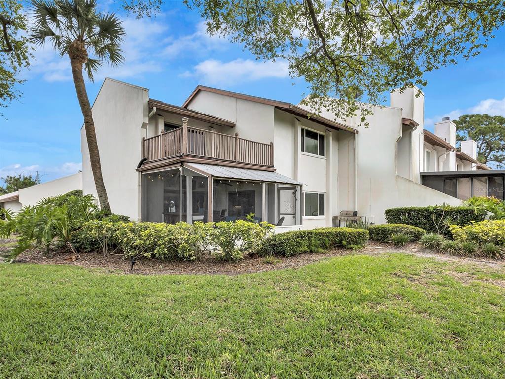7581 Cumberland Road, Unit 7 Seminole, FL 33777 - Photo 2 of 68 a front view of a house with a garden