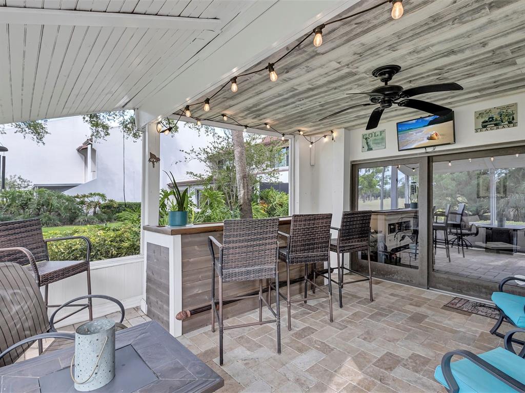7581 Cumberland Road, Unit 7 Seminole, FL 33777 - Photo 24 of 68 a outdoor space with the couches and dining table with the garden view