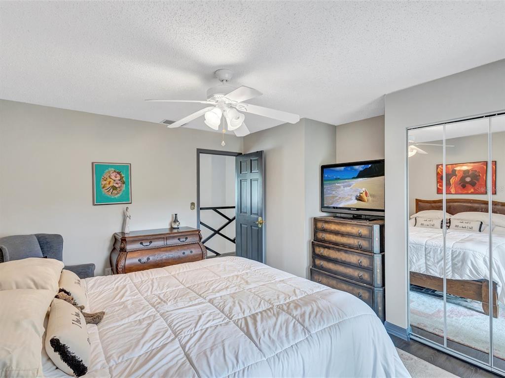 7581 Cumberland Road, Unit 7 Seminole, FL 33777 - Photo 28 of 68 a bedroom with a bed and a chandelier