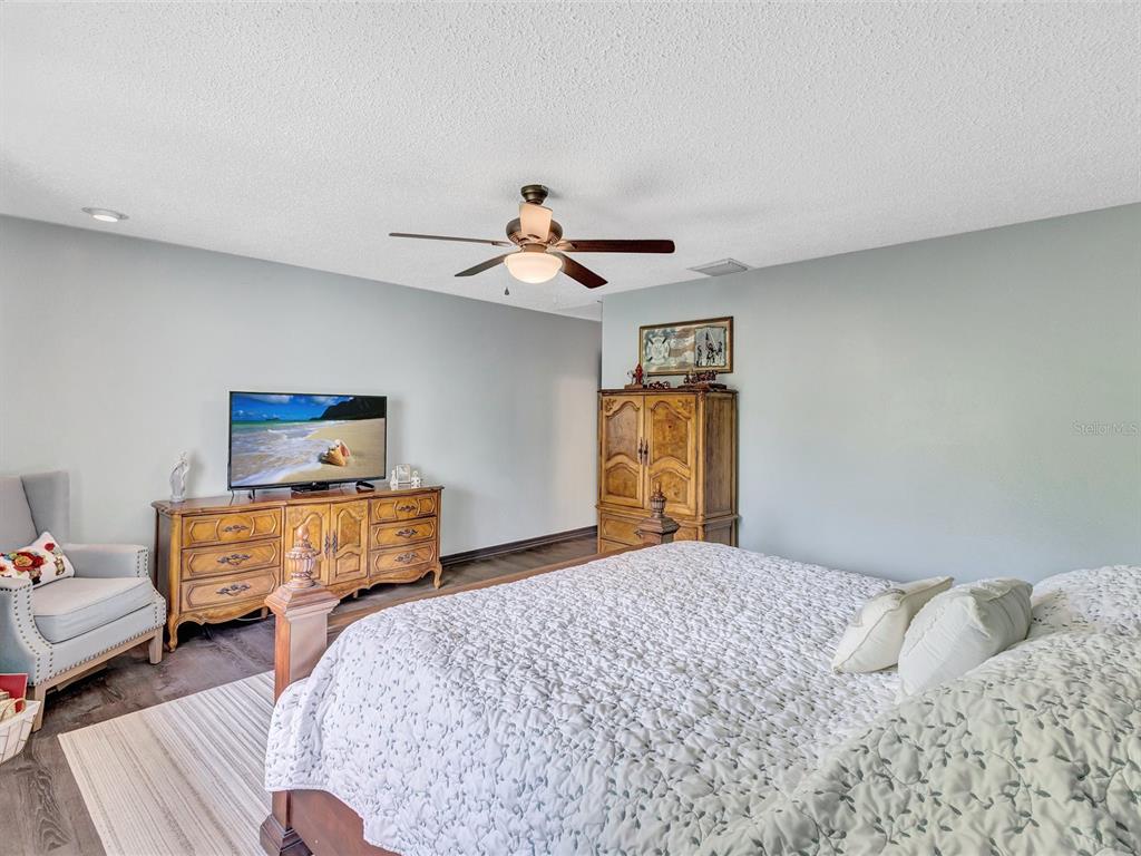 7581 Cumberland Road, Unit 7 Seminole, FL 33777 - Photo 35 of 68 a bedroom with a bed and a chandelier