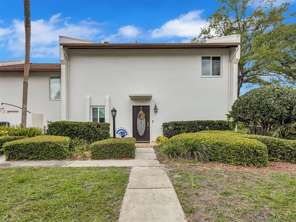 7581 Cumberland Road, Unit 7 Seminole, FL 33777 - Photo 42 of 68 a front view of a house with garden