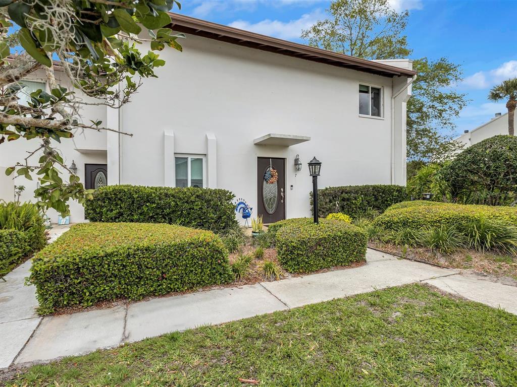 7581 Cumberland Road, Unit 7 Seminole, FL 33777 - Photo 59 of 68 a front view of a house with garden