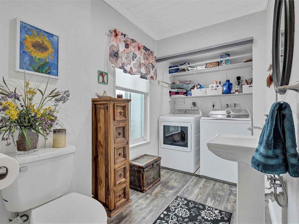 7581 Cumberland Road, Unit 7 Seminole, FL 33777 - Photo 6 of 68 a bathroom with a sink a toilet and a shower curtain