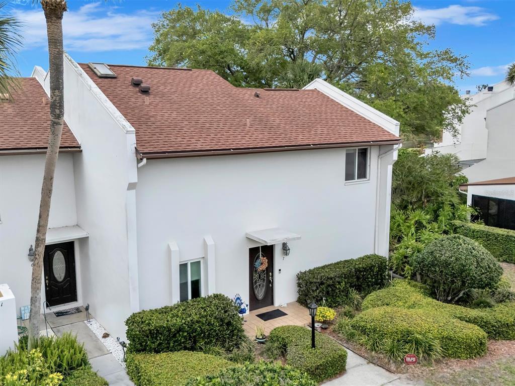 7581 Cumberland Road, Unit 7 Seminole, FL 33777 - Photo 64 of 68 a aerial view of a house with a yard and potted plants