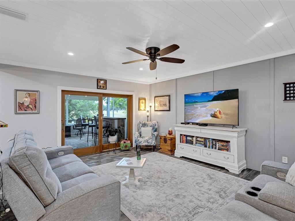 7581 Cumberland Road, Unit 7 Seminole, FL 33777 - Photo 8 of 68 a living room with furniture a flat screen tv and a large window