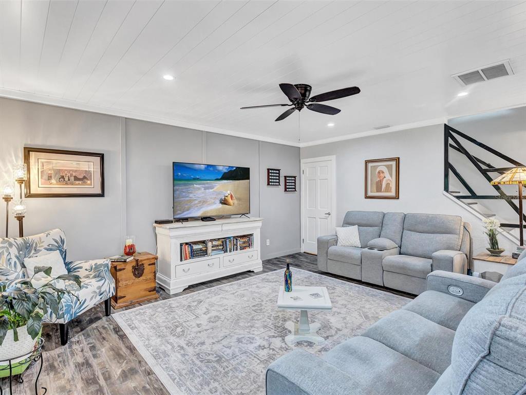 7581 Cumberland Road, Unit 7 Seminole, FL 33777 - Photo 10 of 68 a living room with furniture and a flat screen tv