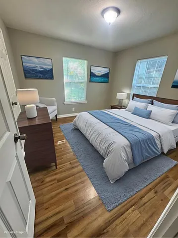 a view of walk in closet with wooden floor