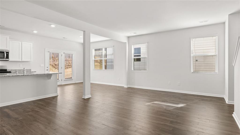 177 Lauritsen Way Newnan, GA 30265 - Photo 11 of 37 a view of an empty room with wooden floor and a window
