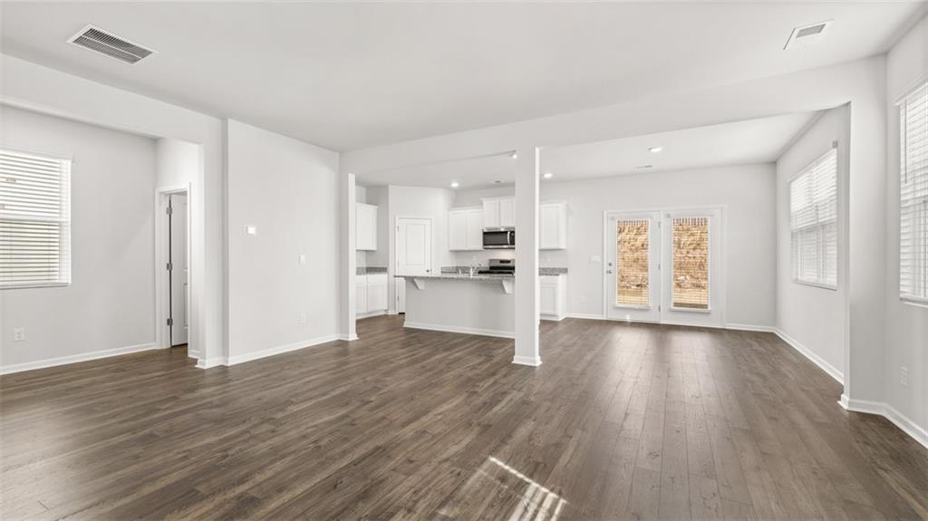177 Lauritsen Way Newnan, GA 30265 - Photo 14 of 37 a view of an empty room with window and wooden floor