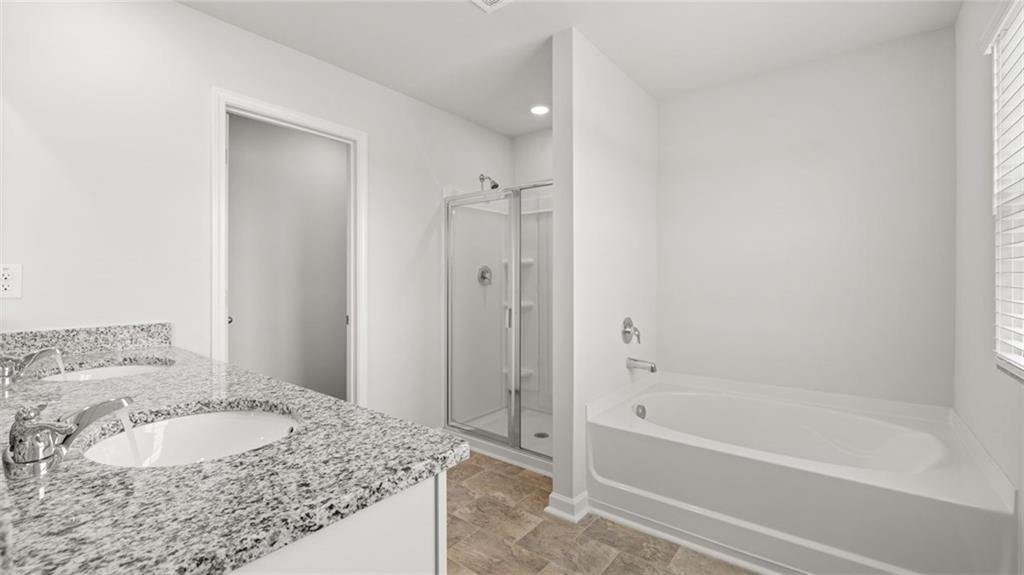 177 Lauritsen Way Newnan, GA 30265 - Photo 19 of 37 a bathroom with a granite countertop tub sink and mirror