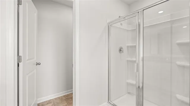 a bathroom with a glass shower door