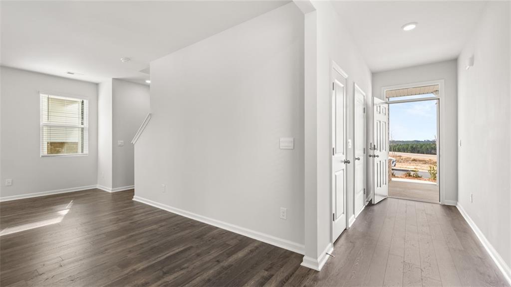 177 Lauritsen Way Newnan, GA 30265 - Photo 4 of 37 a view of a hallway with wooden floor and a living room